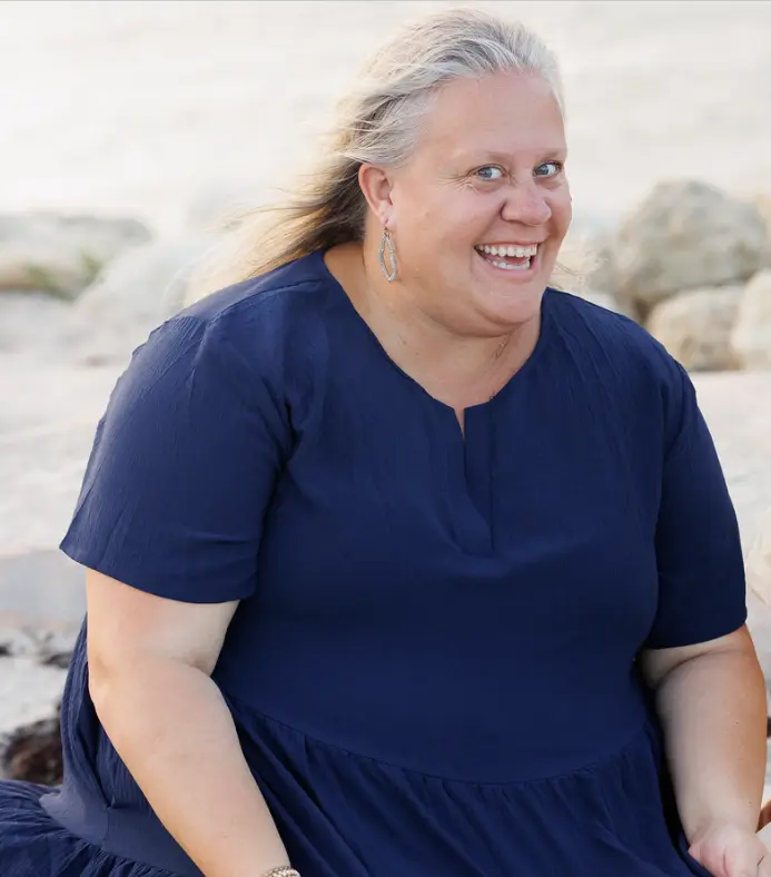 Libby, founder and lead instructor of Rising Moon Swim Academy, smiling in a warm portrait